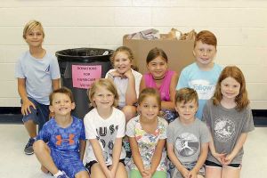 Students, staff and parents from Braelinn Elementary School are collecting disaster relief supplies to help the relief efforts in Texas. Back row, L-R, Jackson Schwieger, Ella Kinsinger, Perry Schwieger, Drew Laughlin. Front row, L-R, Drew Kinsinger, Katie Kinsinger, Elllie Schwieger, Ryan Laughlin, Lydia Laughlin. Photo/Braelinn Elementary School.