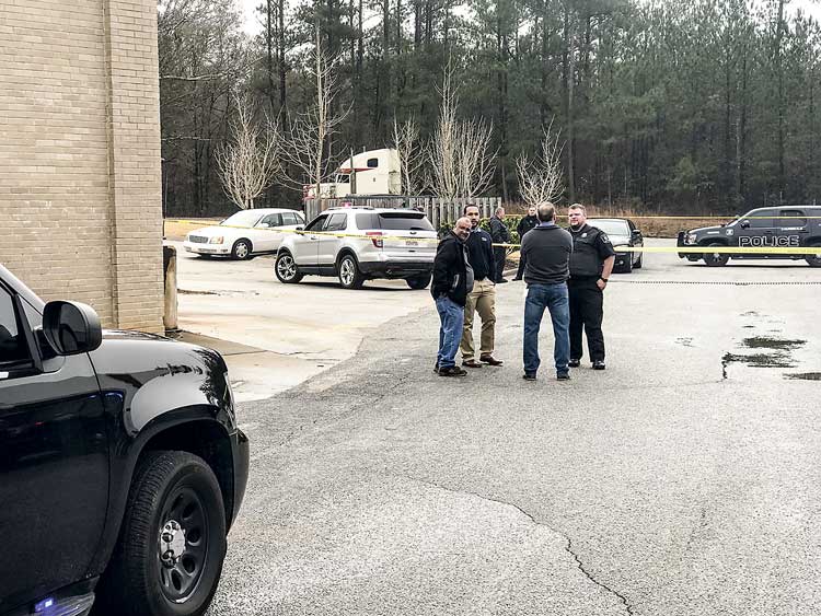 Tyrone officers interview witnesses in the Monday robbery of the O’Reilly’s Auto Parts store on Tyrone Road near Ga. Highway 74 in Tyrone. No one was injured in the incident where shots were fired. Photo/Ben Nelms.
