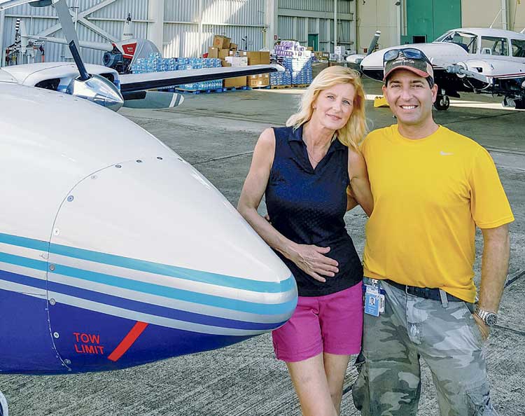 news_01-24-18_Puerto-Rico-mercy-flight_Holly-and-I-in-front-of-Arlet-Aviation.--They-offered-their-hangar-for-free-storage-of-supplies