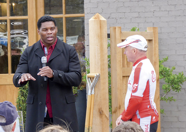 University of Georgia football legend Herschel Walker, left, speaks with Pinewood Forest Chief Visionary Dan Cathy and the large group of people attending the March 16 groundbreaking for the Piedmont Wellness Center located at Pinewood Forest in Fayetteville. Photo/Ben Nelms.