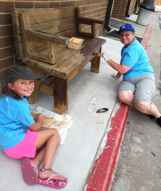 Cheryl Bancroft and granddaughter, Brooke Anderson, touch up an old bench with new paint. Photo/Special.