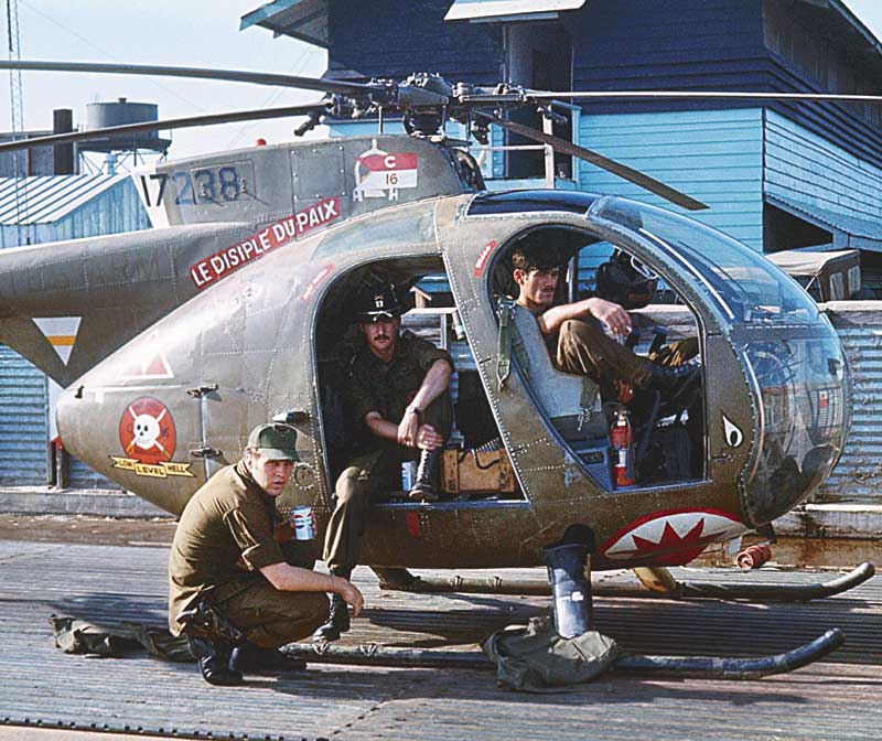 Mike King (front seat) and Hugh Mills (back seat) taking a break in Mike’s OH-6a “Loach.”