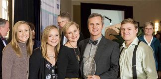 Above, holding the award for 2018 Outstanding Business Person of the Year from the Fayette County Chamber of Commerce is (center) Joe Domaleski, flanked by (L-R) daughters Tori and Alex, wife Mary Catherine and son Stephen. Photo/Roger Sibaja, Gobi Photography.