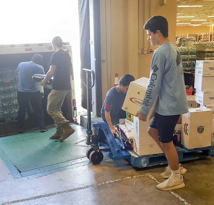 Carson and Taylor Kamal loading box truck full of relief supplies bound for hurricane-ravaged Puerto Rico. Photo/Danny Kamal.