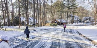 A Peachtree City resident shared this picture of a neighborhood near Lake Peachtree and how some of the neighbors were making use of an uncommon mid-week day off because of snowfall. Photo/Jennifer Vetter.