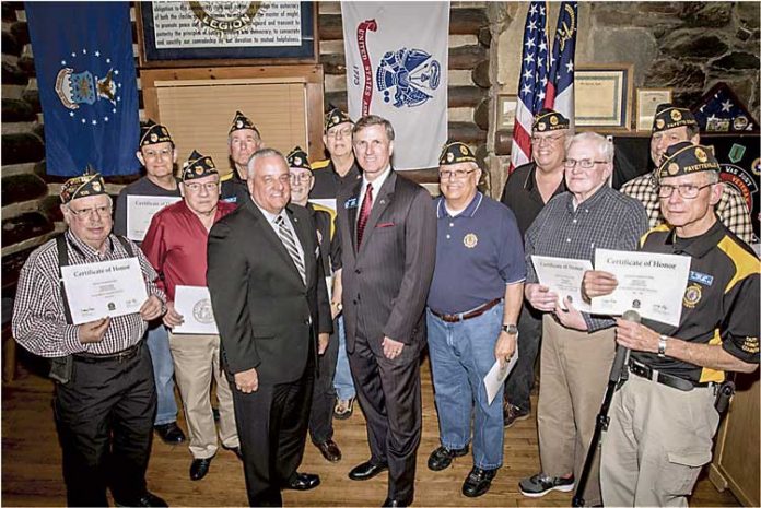 GDVS Commissioner Mike Roby (center, left) and state Sen. Marty Harbin (center, right) presented members of American Legion Post 105 with their Vietnam War Certificates of Honor. The Legionnaires received their certificates at a ceremony held at the “Log Cabin” in Fayetteville in February 2016. Photo/Submitted.