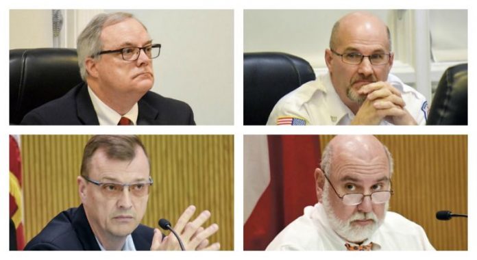 From top left clockwise, Fayette County Human Resources Director Lewis Patterson, 9-1-1 Director Bernard ‘Buster’ Brown, Commission Chairman Eric Maxwell, and Commissioner Steve Brown. Photos/Ben Nelms.