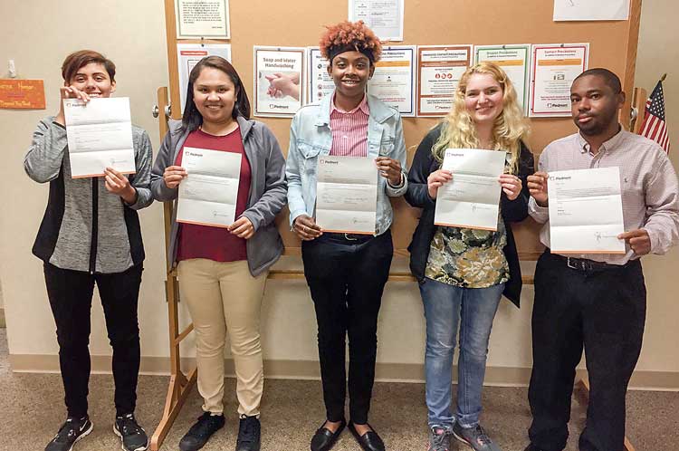 The students with their acceptance letters are (L-R) Eden, Jazmin, Chanelle, Danielle and Josh. The acceptance letters are from the departments they will be working in at Piedmont Fayette. Photo/Piedmont Fayette Hospital.