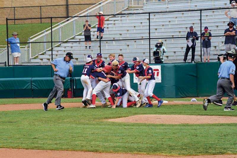 Peachtree City teammates celebrate after winning the Southeast Regional. Photo/Geoff Dale.