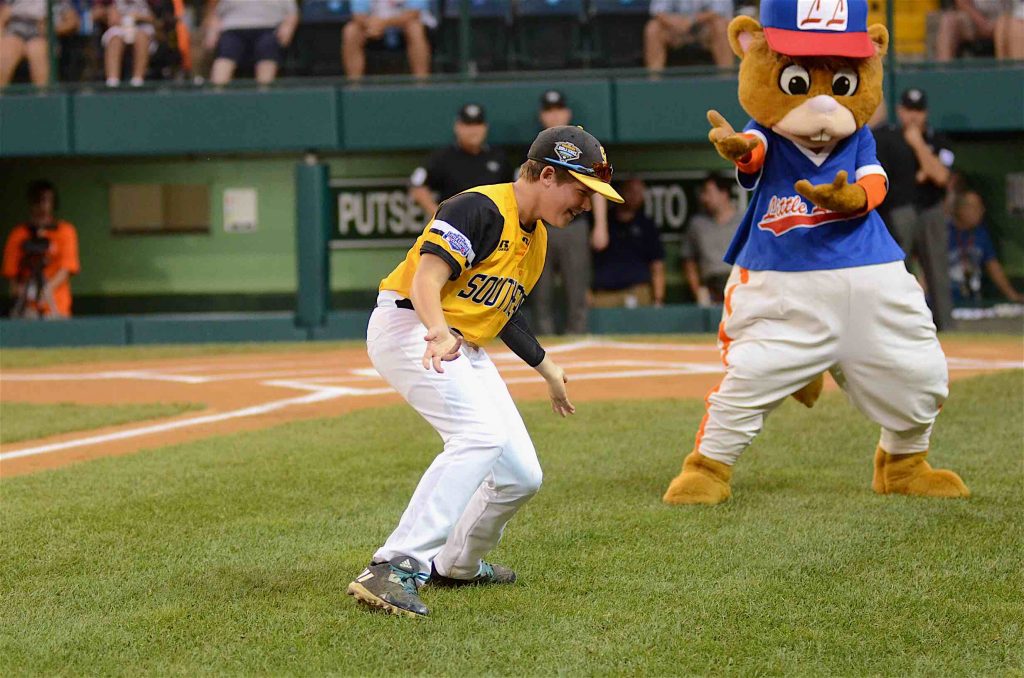 Peachtree City’s James Hooper breaks it down during a pregame showdown with Little League mascot Dugout. Hooper and Dugout eventually danced together for the fans. Photo/Brett R. Crossley.