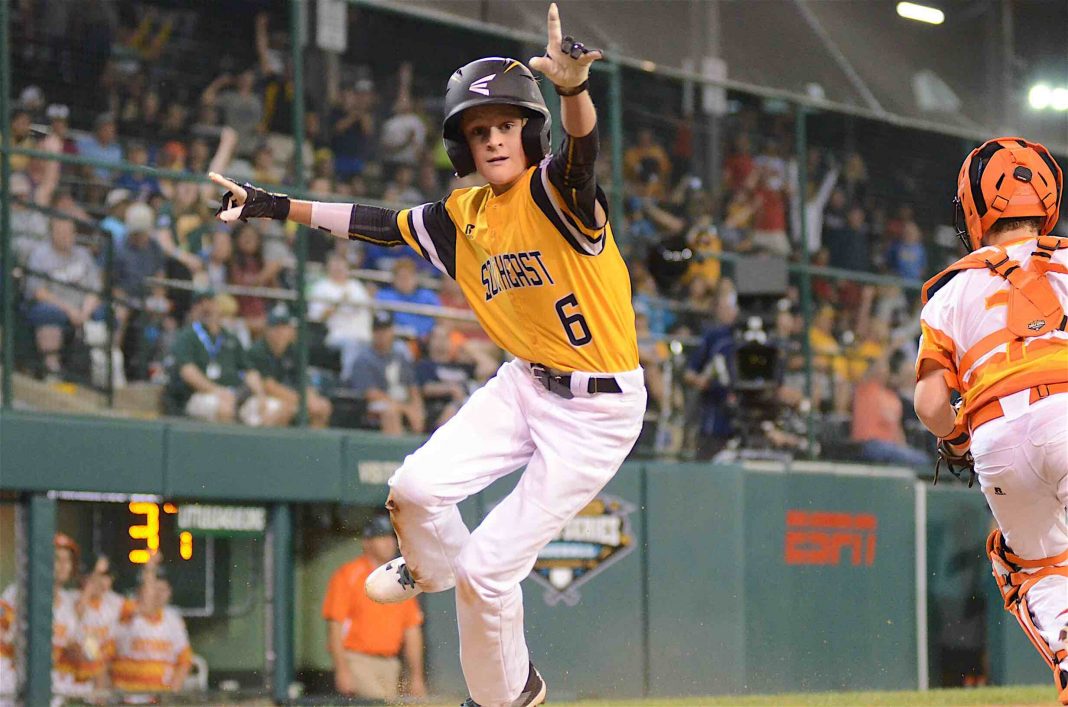 Peachtree City’s Wills Maginnis jumps up from home after scoring the game-winning run of a Little League World Series game against the Southwest. Photo/Brett R. Crossley.