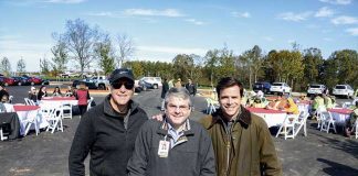 Pinewood Forest President Rob Parker, Piedmont Fayette CEO Michael Burnett, and Brasfield and Gorrie Vice President Reed Weigle with the final steel beam of the Piedmont Wellness Center at Pinewood Forest. Photo/Christopher Fairchild.