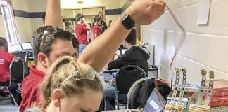 Whitewater High student Catie Hayes does some last minute prep work to get one of the VEX robots ready for competition. Photo/Fayette County School System.