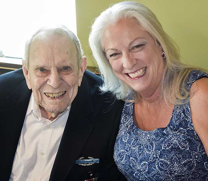 A local institution herself, Mimi Gentilini of Mili's God Food restaurant, chats with one of her favorite customers, Frank Forth. Photo/Tony Armstrong.