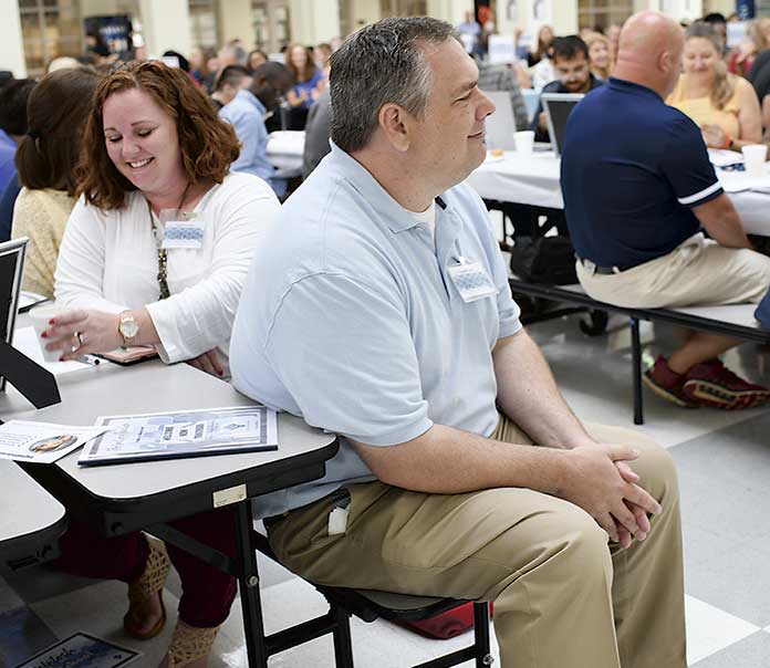 <b>McIntosh High School Teachers Janell Brown and Paul Sams enjoy a laugh as Dr. Barrow, Fayette County Public School System superintendent, shares a funny story during his welcome to the teachers. Photo/Fayette County School System. </b>