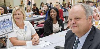 Sandy Creek High teacher Laura-Leigh Reynolds sits across from interim principal Richard Smith as they listen to Kim Herron, director of elementary education, deliver the first welcoming remarks to kick-off the 2019 New Teacher Induction. Photo/Fayette County School System.