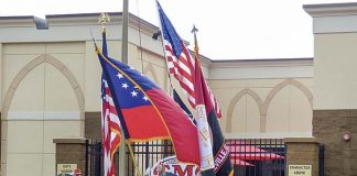 The Georgia Military College Color Guard posts the colors and the Marine Corps League, Maj. Stephen W. Pless Detachment 1196, at rear, raises Old Glory at the Aug. 20 grand opening of GMC’s Phase 2 expansion in Fayetteville. Photo/Ben Nelms.