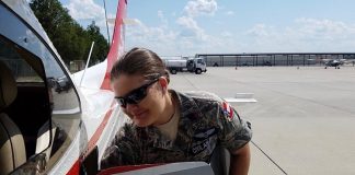 Cadet Chief Master Sergeant Dawn Patrick gathers her belongings after completing an airborne photographic mission in the aftermath of Hurricane Dorian. Photo/Civil Air Patrol mission pilot Lt. Col. Larry Taylor.