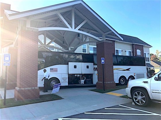 Logan Johnston (L), executive director of Heartis Fayetteville, welcomes residents and staff of Portside at Grande Dunes from South Carolina. Photo/Joyce Beverly.