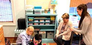 Becky Hall, certified therapy dog trainer, reads to the Lower School class with therapy dog Libby, while teacher Caroline Breslin (from left) and teacher assistant Martha Butler look on. Photo/Submitted.