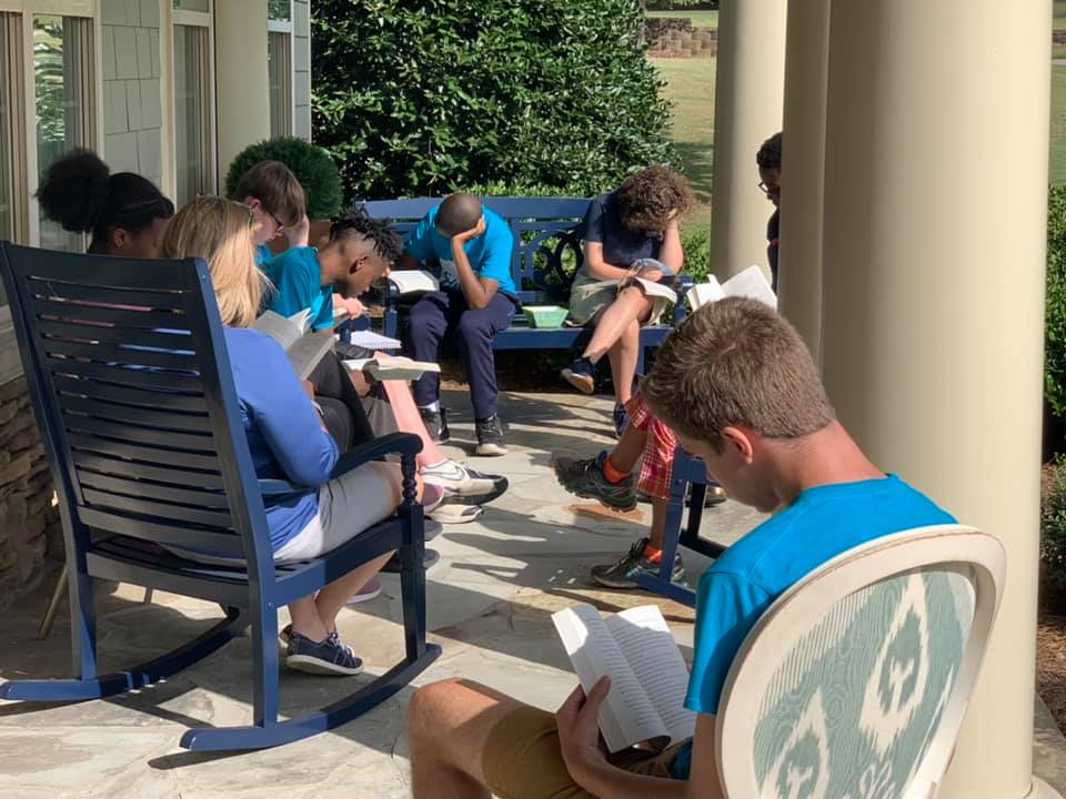 <b>Virginia Warrick, a teacher for ClearWater Academy’s upper school, and her students read together the novel entitled, “The Giver,” by Lois Lowry. Photo/Submitted.</b>