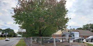 The fence in front of the old school system building on Ga. Highway 54 in Fayetteville is in place for the upcoming demolition of the building, set for the next few days. Photo/City of Fayetteville.