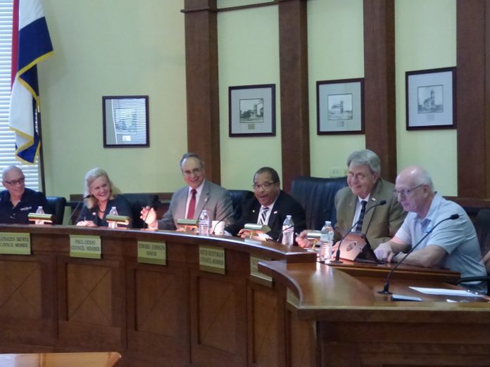 Approving an application on Oct. 3 to receive funding for a feasibility study for the city’s path system were, from left, Fayetteville council members Harlan Shirley, Kathaleen Brewer and Paul Oddo, Mayor Ed Johnson and councilmen Rich Hoffman and Scott Stacy. Photo/Ben Nelms.