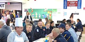 One of the chefs at the 29th Annual Pancake Breakfast held Jan. 25 at McIntosh High School took time to sit with firefighters enjoying a meal. As it turns out, the chef looks a lot like Peachtree City Fire Chief Joe O’Conor. Photo/Ben Nelms.