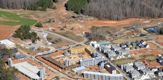 A drone shot of the current development at Pinewood Forest shows, at center and left center, the three large buildings that will house 40,000 sq. ft. of retail and 263 apartments when completed in late 2020. Photo/Pinewood Forest.