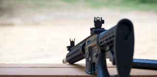 An AR-15 semi-automatic rifle on a bench rest. Shutterstock photo.