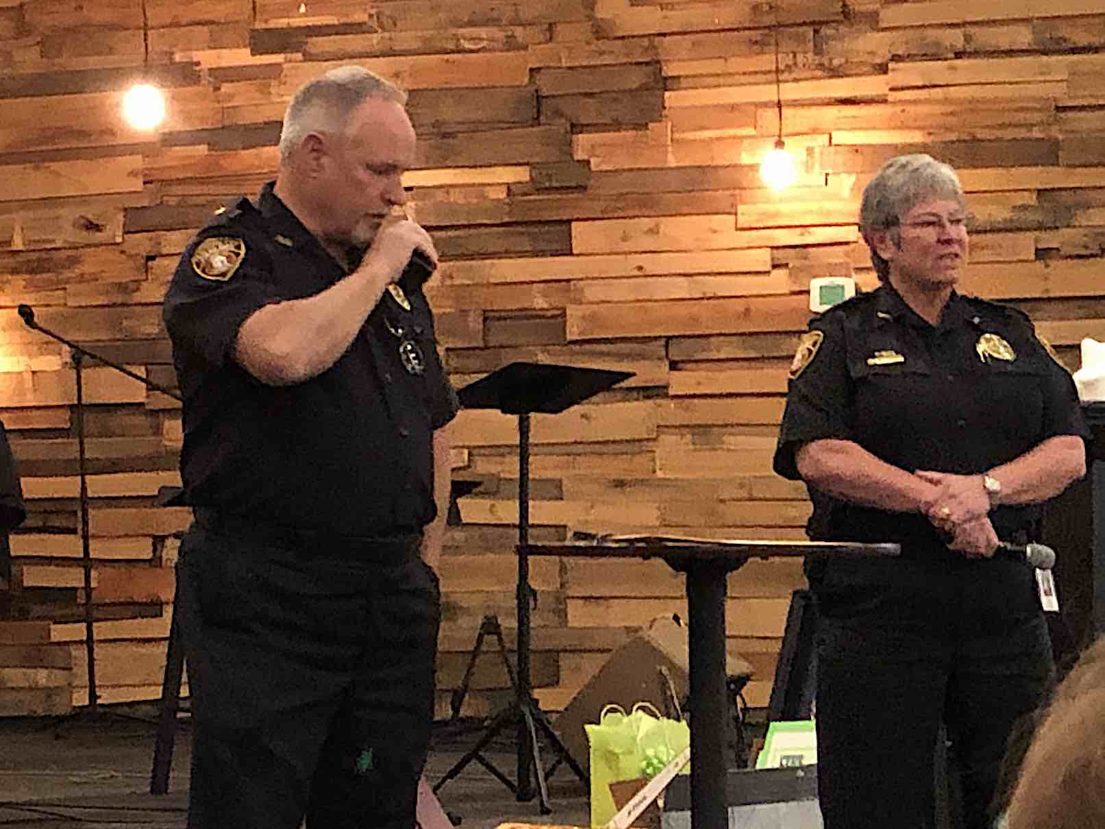 <b>Assistant Chief Stan Pye makes his final police radio call and signs off. Chief Janet Moon is at right. Photo/Cal Beverly.</b>