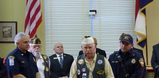 Fayetteville Fire Department Captain Sean Venza on Feb. 20 received the VFW Post 3650 Public Servant Award. Pictured, from left, are Chief Alan Jones, VFW member Larry Dell, VFW member Ron Stubbs and Sean Venza. City Council members, at rear, stood with the group during the presentation. Photo/Ben Nelms.