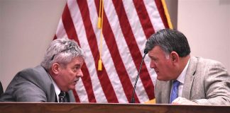 Peachtree City Manager Jon Rorie (L) and City Councilman Mike King have a chat before the meeting gets underway March 5. Photo/Cal Beverly.