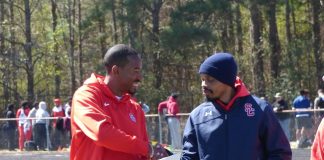 Olympic champion and world champion track and field athlete, and Sandy Creek High School graduate, Christian Taylor on March 7 was honored for his accomplishments at Sandy Creek High School stadium, where the Christian Taylor Invitational was held. Pictured with Taylor, at left, is Sandy Creek Head Track Coach Jeremy Easley. Photo/Ben Nelms.