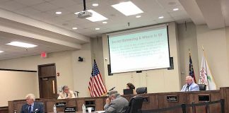 Properly separated for social distancing rules, the five members of the Peachtree City Council get ready to hear the first agenda item at the May 21 meeting at City Hall. Photo/Cal Beverly.