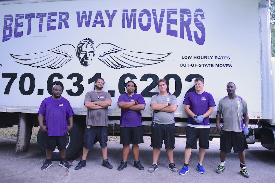 <b>A Better Way Movers crew stand together at the end of a long day of moving a widow and her son into their first home in four years. It was a 2-truck all-day job that was performed at no charge to the family. Photo/Cal Beverly.</b>