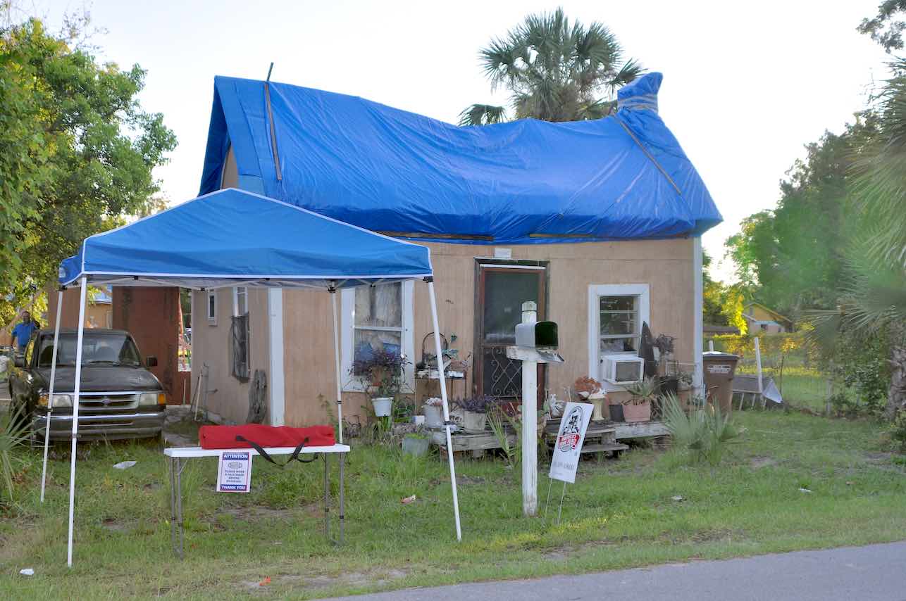 <b>The Before — the home was habitable but only because of the temporary tarps that replaced the blown-away roof. All photos/Square Foot Ministries.</b>