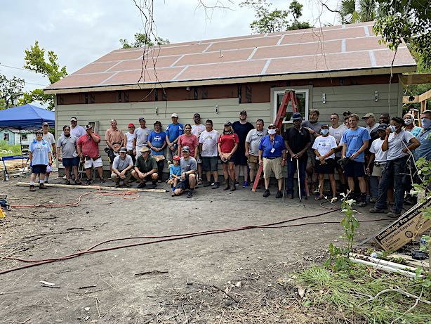 <b> The workers pose for a group portrait. At far left are Jeff Williams (Executive Director) in the white shirt and that’s Maggie Clark in the blue shirt.</b>