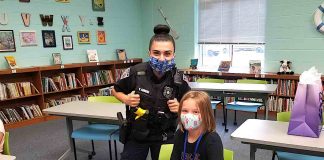 Emmerson Perkins, fourth grade, shows off her Spin ‘n Twirl Gymnast Barbie doll set she received from Fayetteville police officers for her positive behavior and actions.