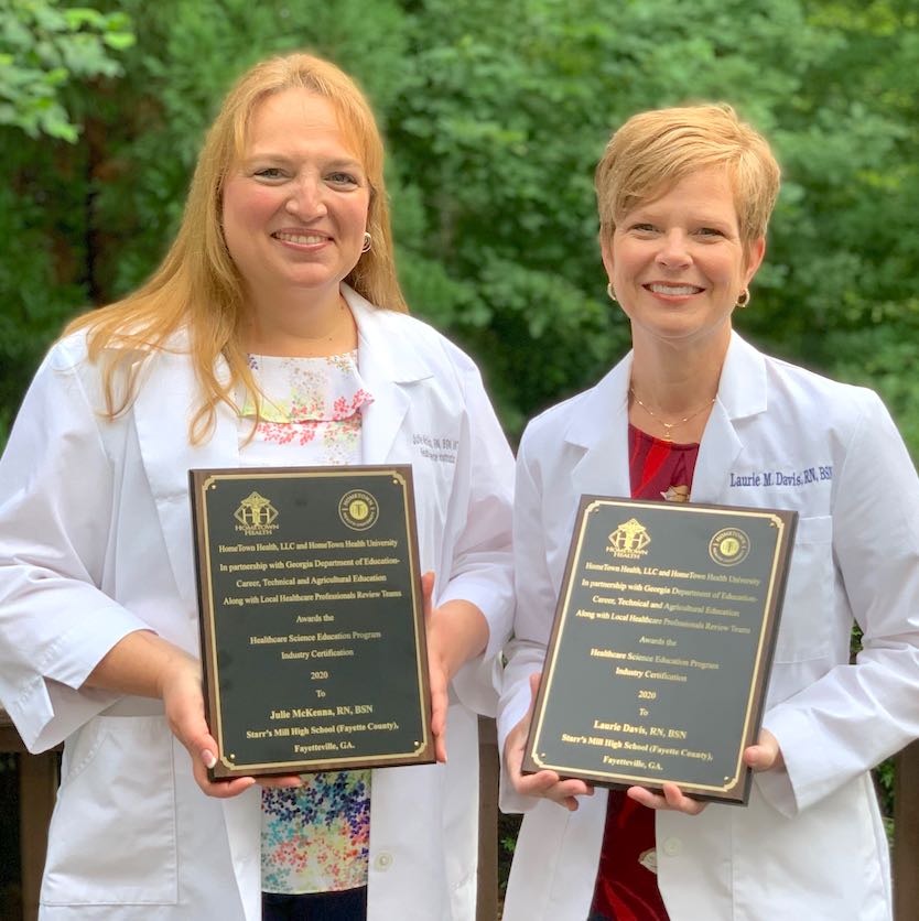 <b>Starr's Mill High School teachers Julie McKenna (L) and Laurie Davis show awards for healthcare science education industry certification. Photo/Fayette County School System.</b>