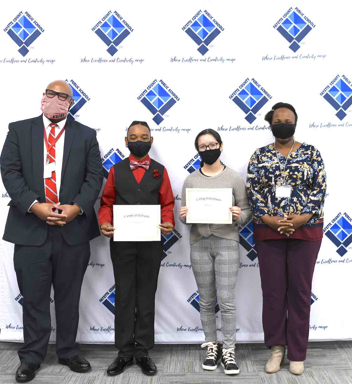 <b>(L-R) Flat Rock’s assistant principal David McBride, Quentin Lunderman, Alexis Vo, and Flat Rock counselor Dionne Burnett.</b>