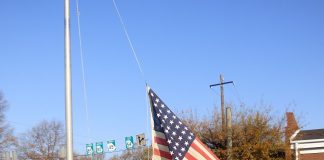 Members of American Legion Post 105 in Fayetteville on Dec. 7, Pearl Harbor Remembrance Day, raised a flag that flew over a military base in Malaysia during World War II. Photo/Ben Nelms.