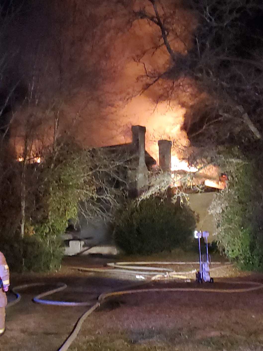 Partly illuminated by Fayette County Fire Department emergency lights, the pre-Civil War home was built by a prominent doctor. Photo/Samuel Patton.