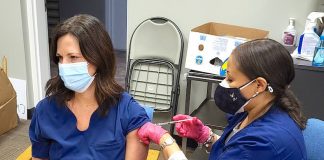 Rising Starr Middle school nurse Tiffany Blair receives the Moderna Covid-19 vaccination from a nurse at the Fayette County Health Department. Photo/Fayette County School System.