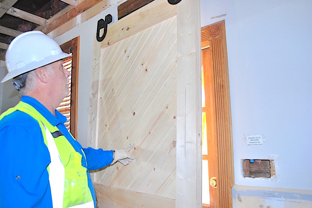 <b>Ron Brown, Senior Superintendent for Randolph Williamson, displays his handiwork on a door he fabricated to match the early 1900s era original. Photo/Submitted.</b>