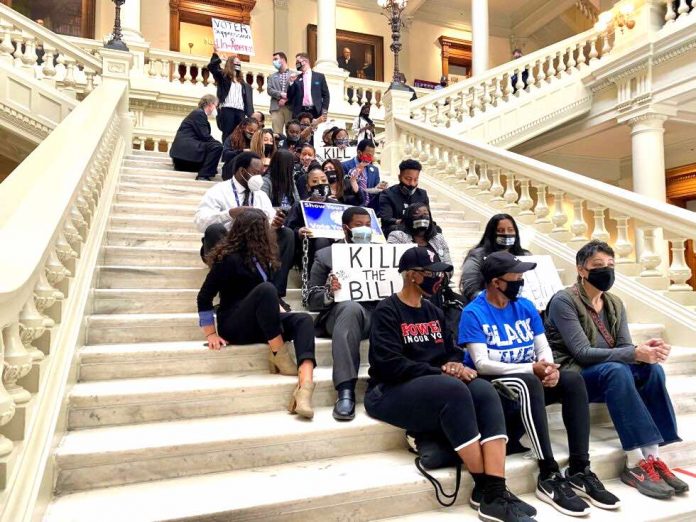 Voting-rights advocates protest inside the state Capitol against Senate Majority Leader Mike Dugan’s (R-Carrollton) elections bill before its passage in the Georgia Senate on March 8, 2021. Photo/Beau Evans.