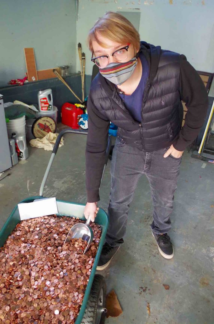 Not exactly pennies from heaven — Andreas Flaten says goodbye to the wheelbarrow full of his employer's final payment to him.Photo/Coinstar.