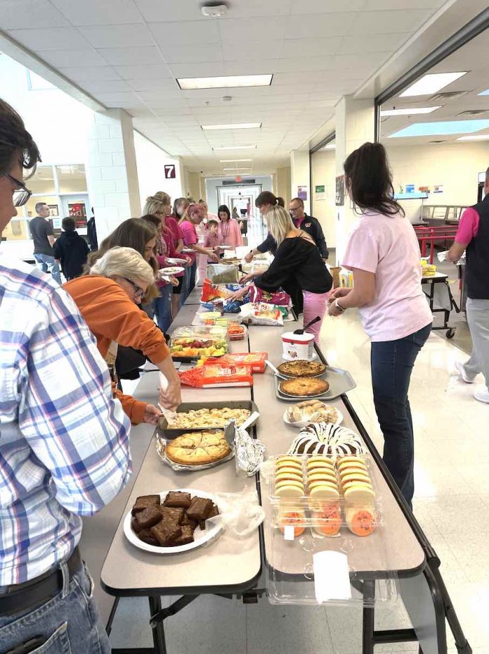 Whitewater High School staff members prepare to treat faculty, students and families to a tailgate feast before Homecoming recently. Photo/Ashley Maddox.