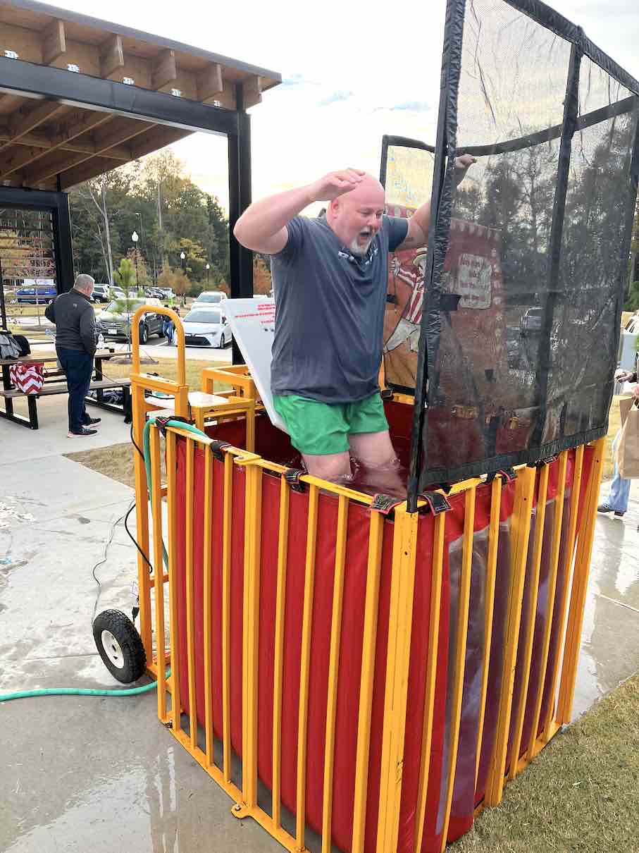 Normally, Fayetteville Police Chief Scott Gray’s job deals with a variety of serious law enforcement issues. But not on Nov. 6 at the Carnival in the Park held at City Center Park. Gray took his turn sitting on the pad in the dunking booth as kids showed off their pitching skills, and hitting the big red button that landed him in the chilly water. Leading by example, Gray by taking the repeated dunks did what most adults will not do, and he had fun doing it. Photo/Ben Nelms.