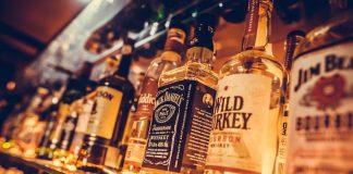 Liquor bottles on package store shelves. Photo/Shutterstock.